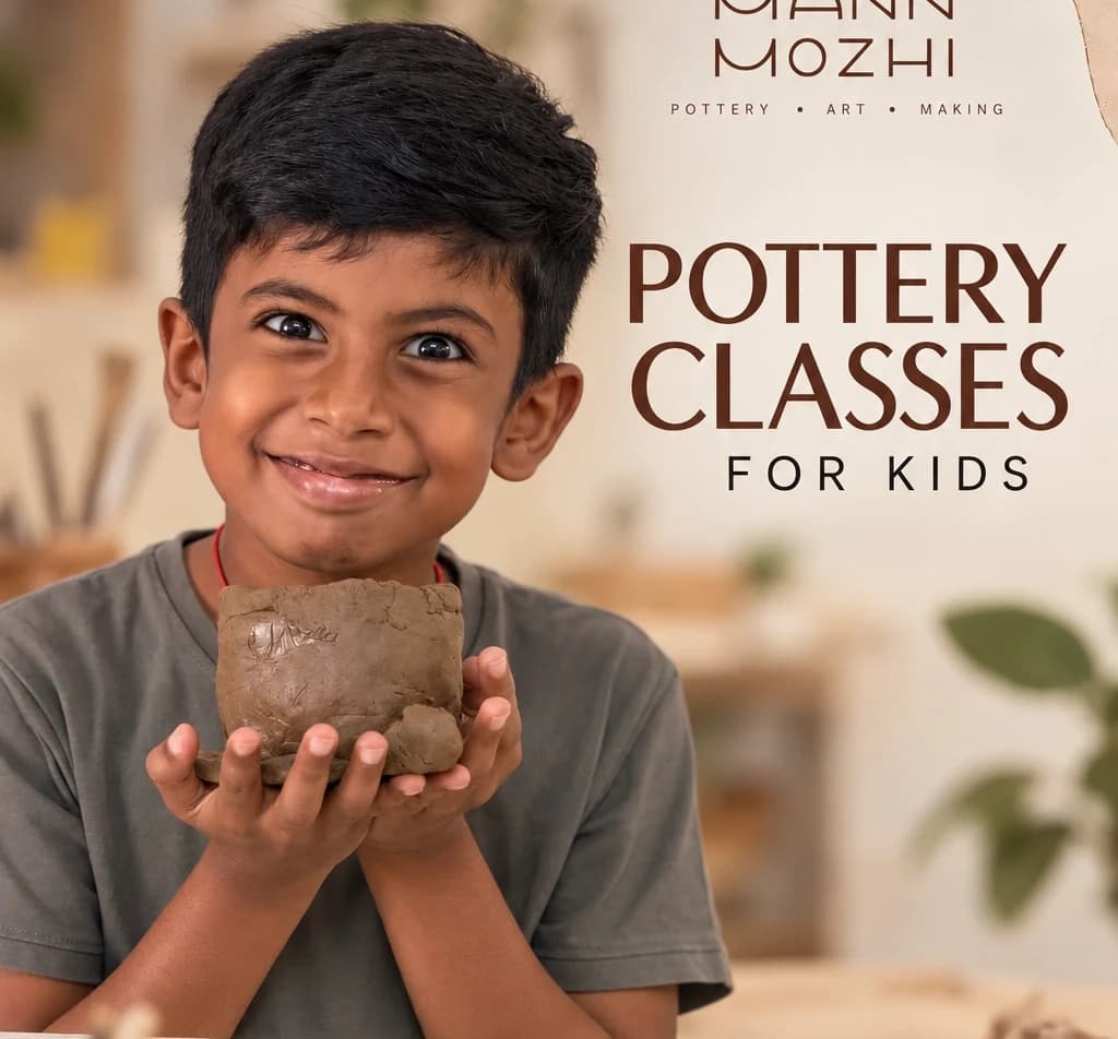 Happy child in Mann Mozhi pottery class holding handcrafted clay vessel