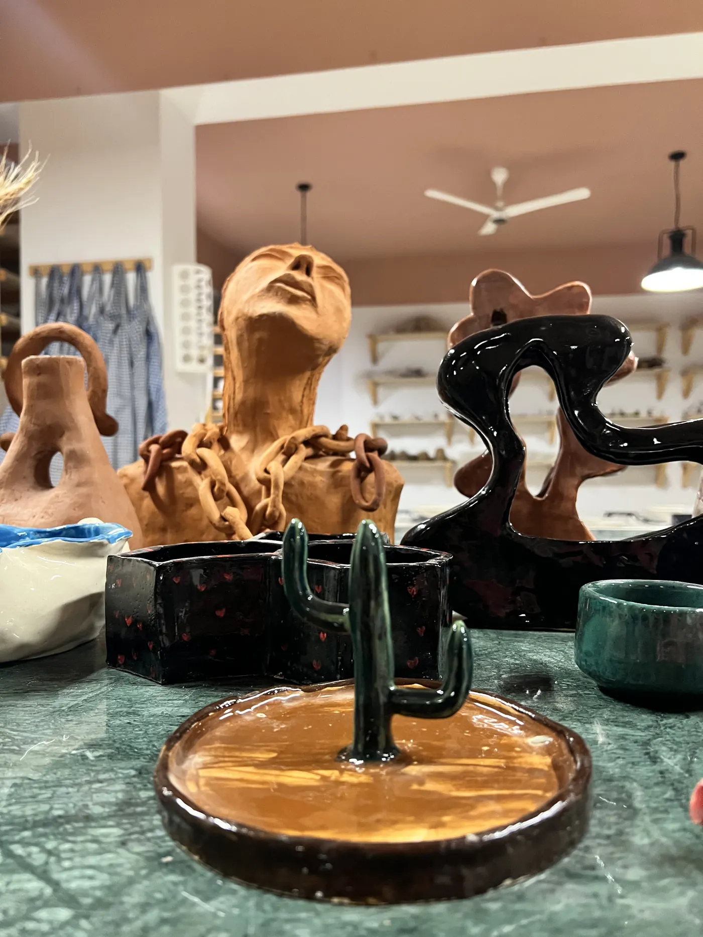 Ceramic sculptures and artistic pieces created in community pottery collaborations