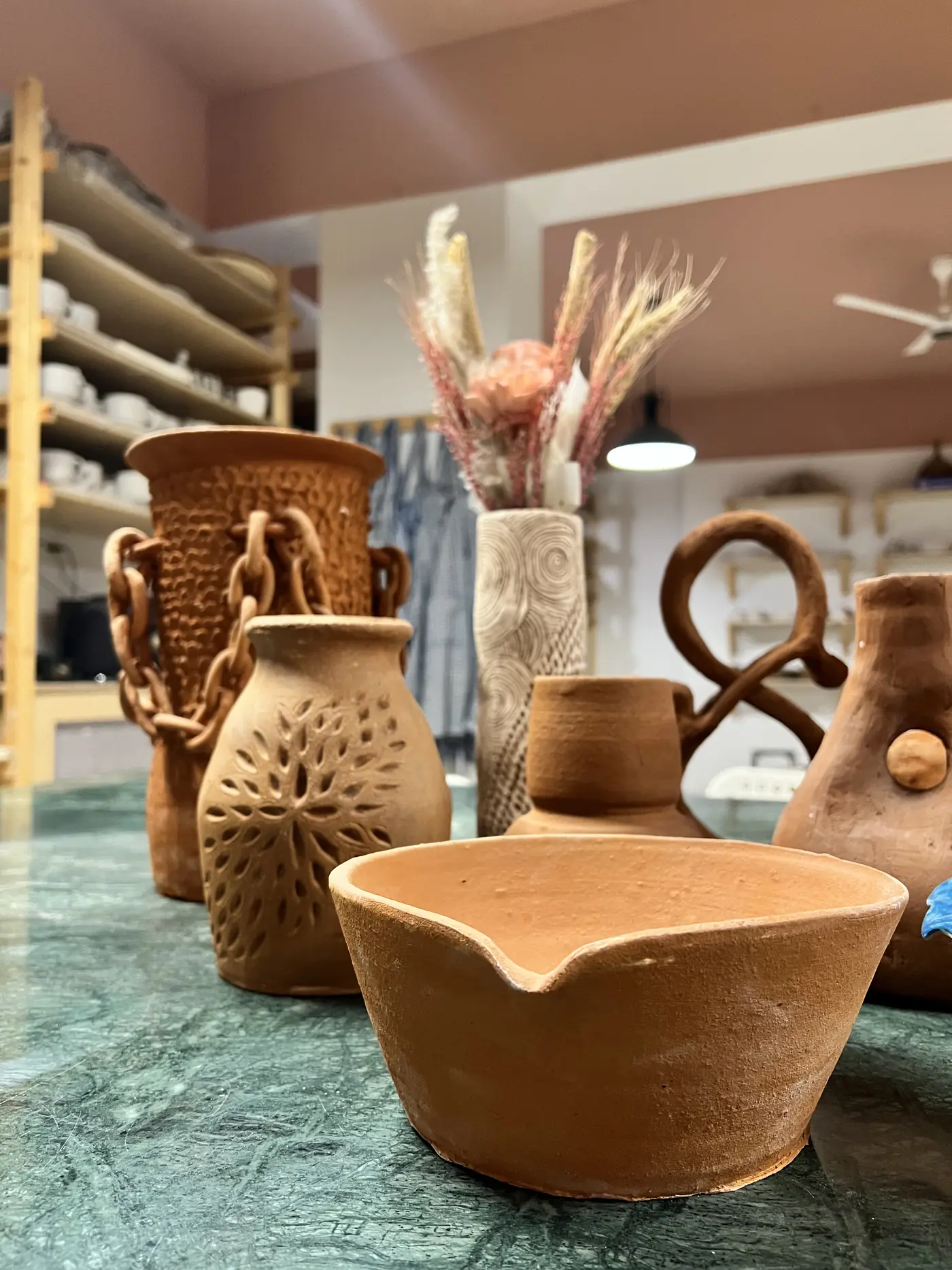 Artistic terracotta vases and pottery arrangements at Logi's home studio